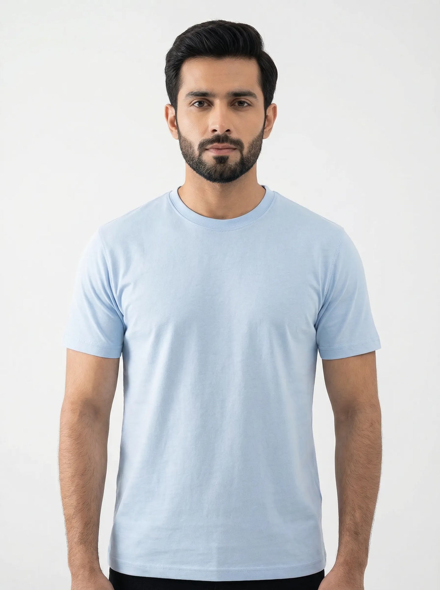 Man wearing a light blue t-shirt against a white background