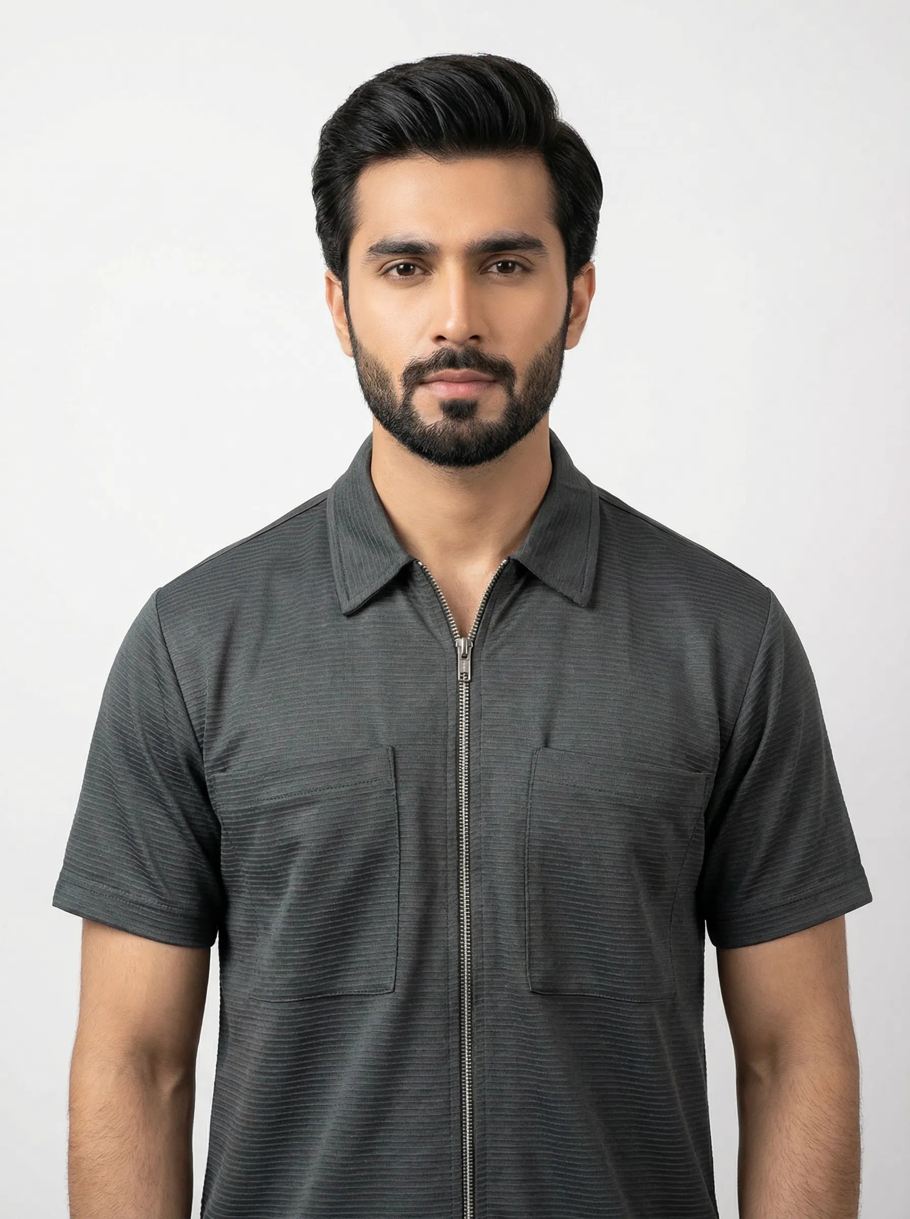 Man wearing a dark gray short-sleeve shirt with a collar on a white background
