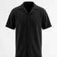 Black short-sleeve button-up shirt on a white background