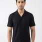 Man wearing a black short-sleeve shirt against a white background