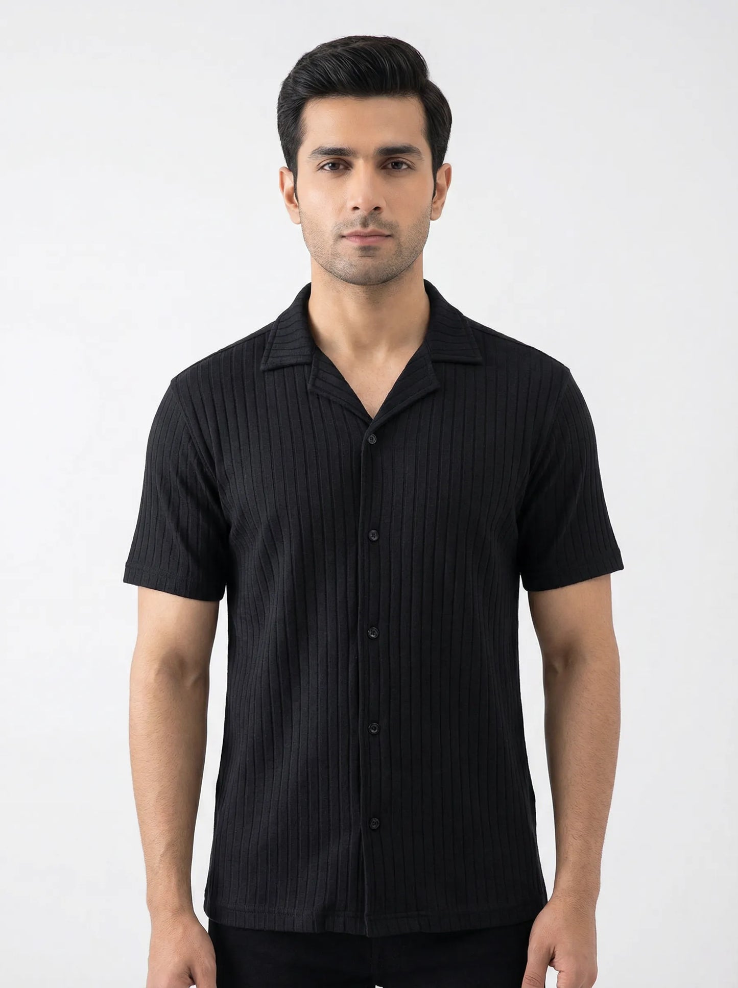 Man wearing a black short-sleeve shirt against a white background