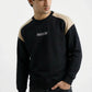 Person wearing a black and beige sweatshirt with 'Aghaz' branding on a white background