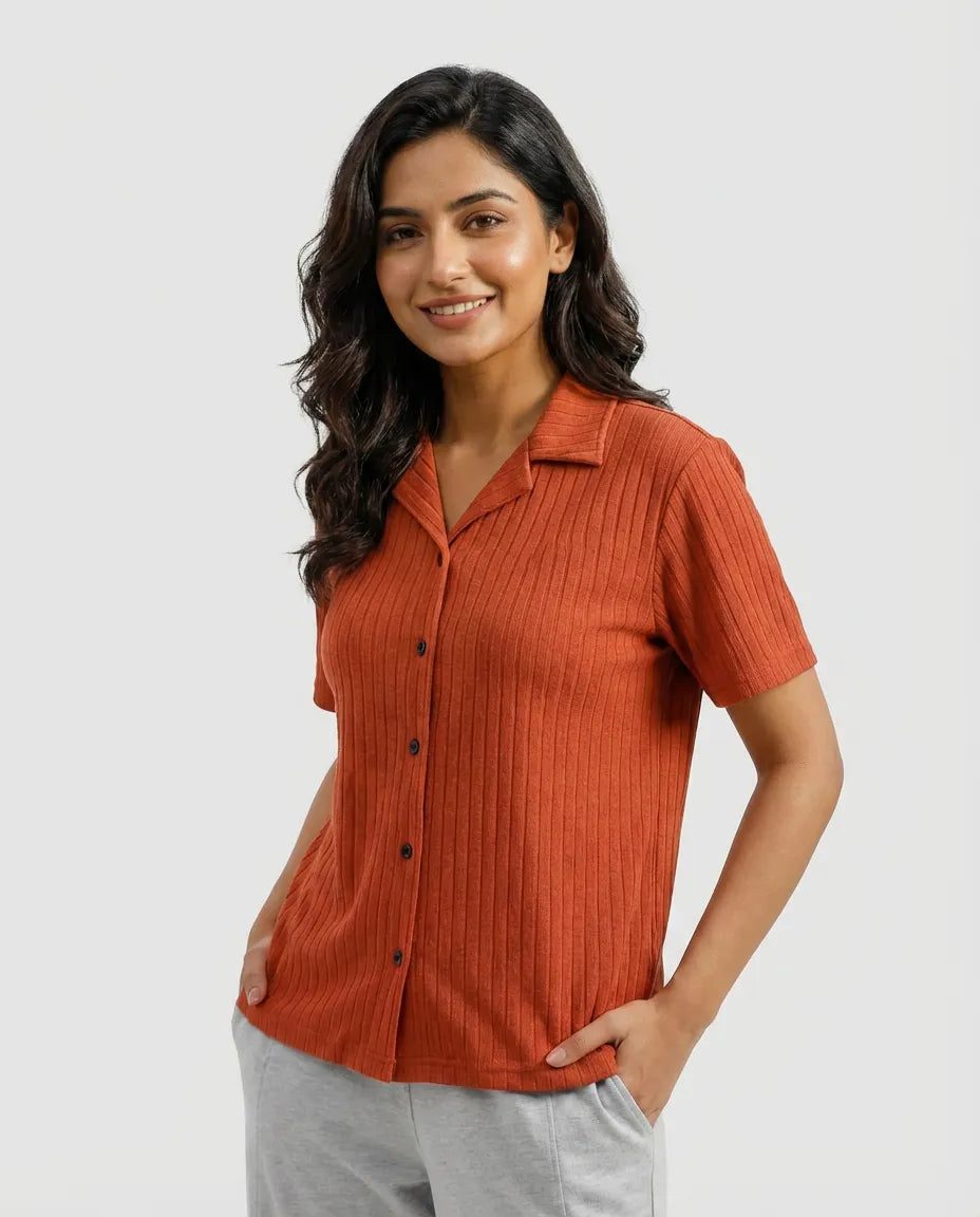 Woman wearing a rust-colored short-sleeve shirt on a white background