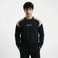 Man wearing a black and beige sweatshirt with 'Aguazz' branding on a white background