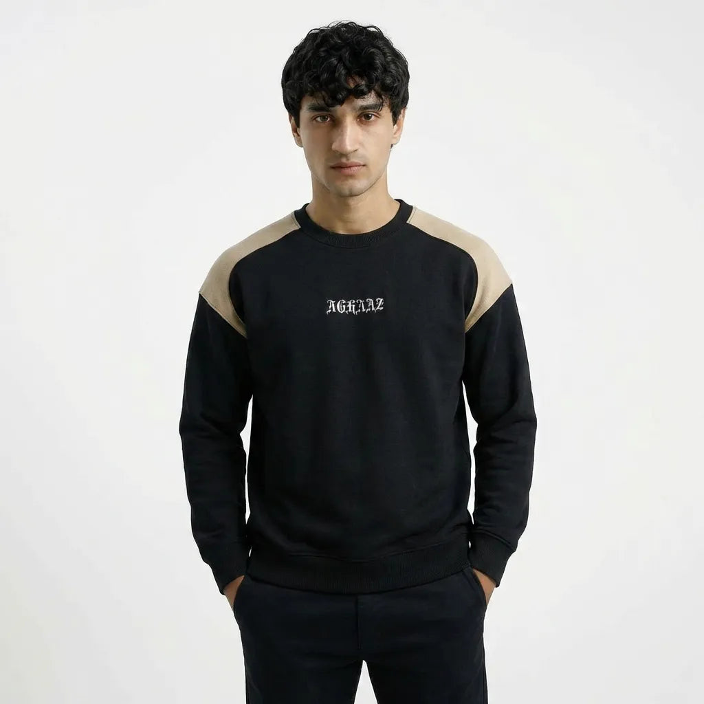 Man wearing a black and beige sweatshirt with 'Aguazz' branding on a white background