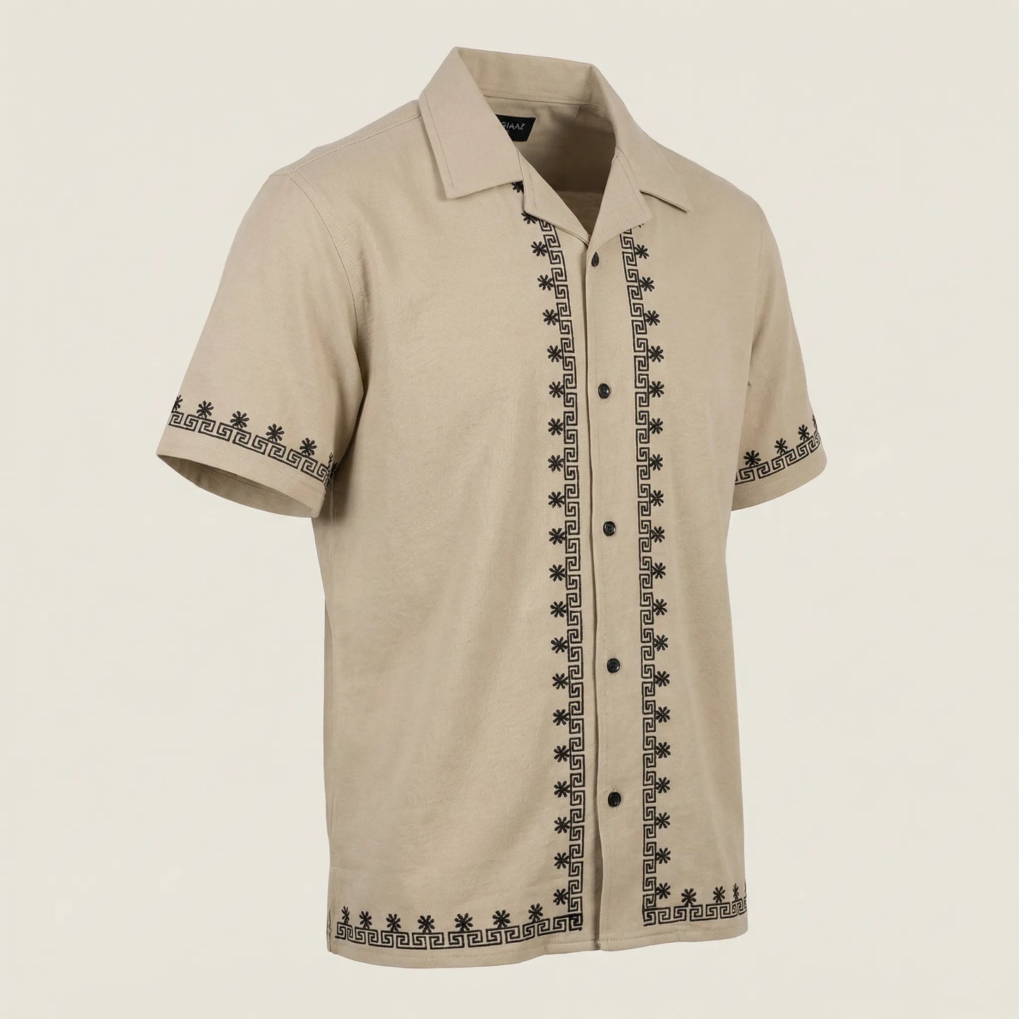 Beige short-sleeve shirt with black embroidery on a beige background