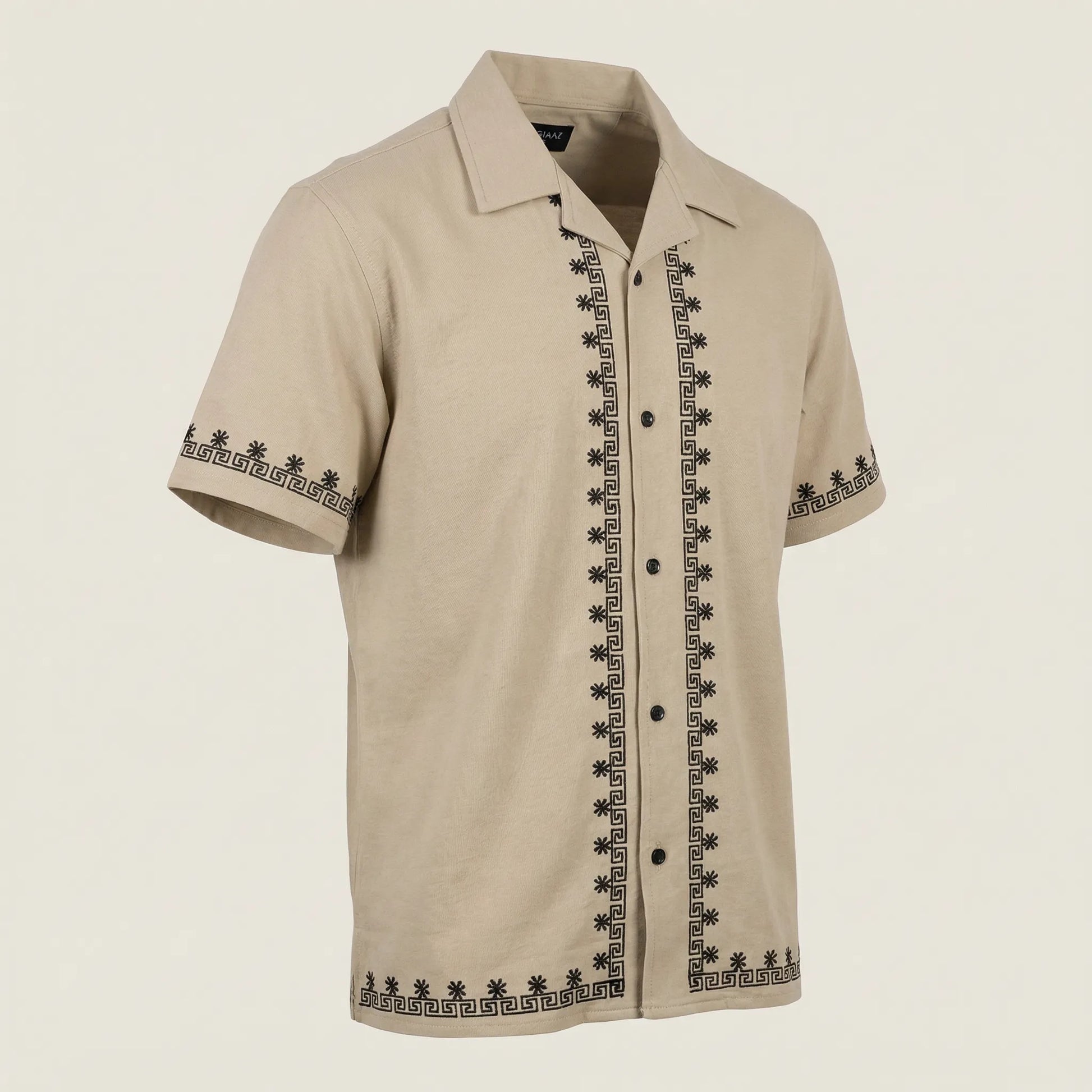 Beige short-sleeve shirt with black embroidery on a beige background